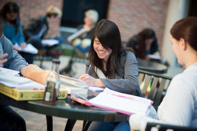 student writing outdoors