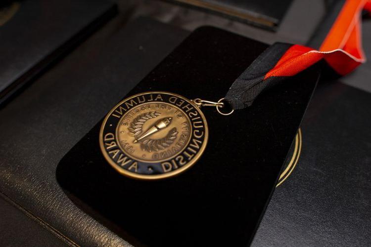 medal reading Distinguished Alumni Award